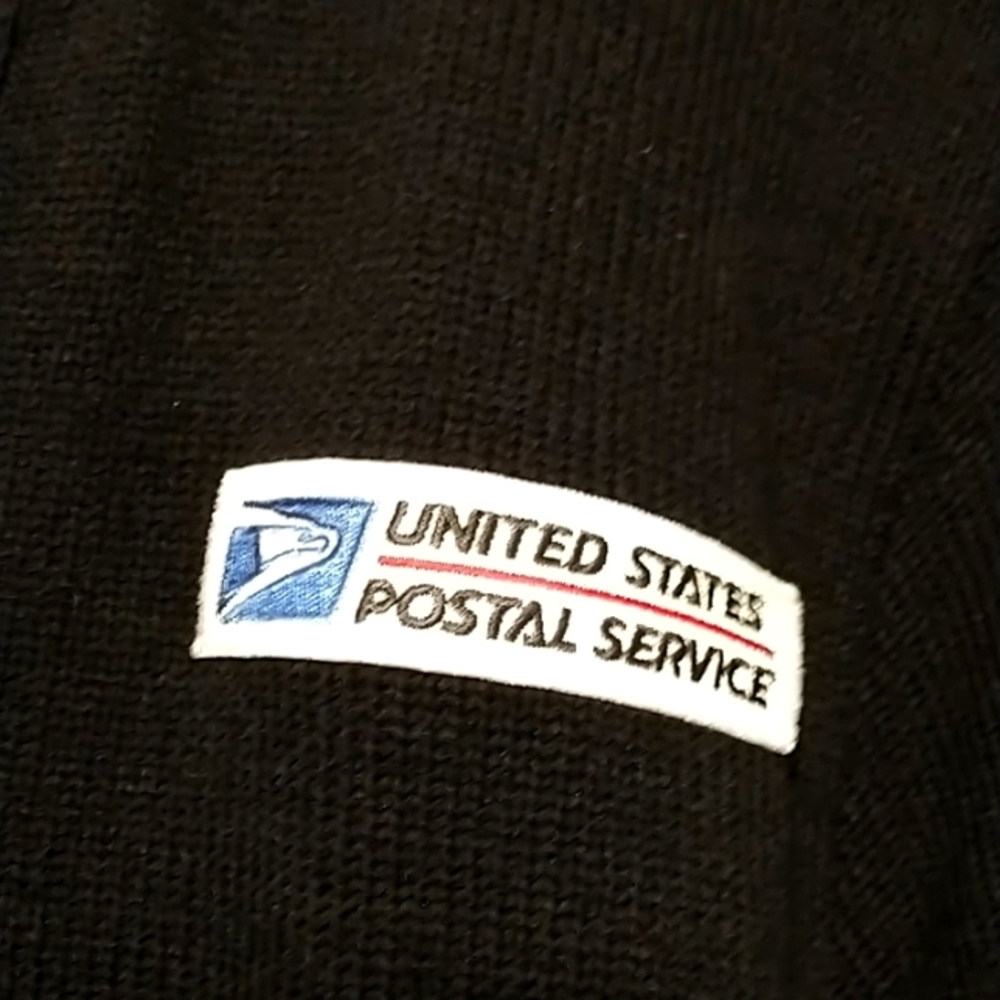 Postal cardigan with a zipper in the front.